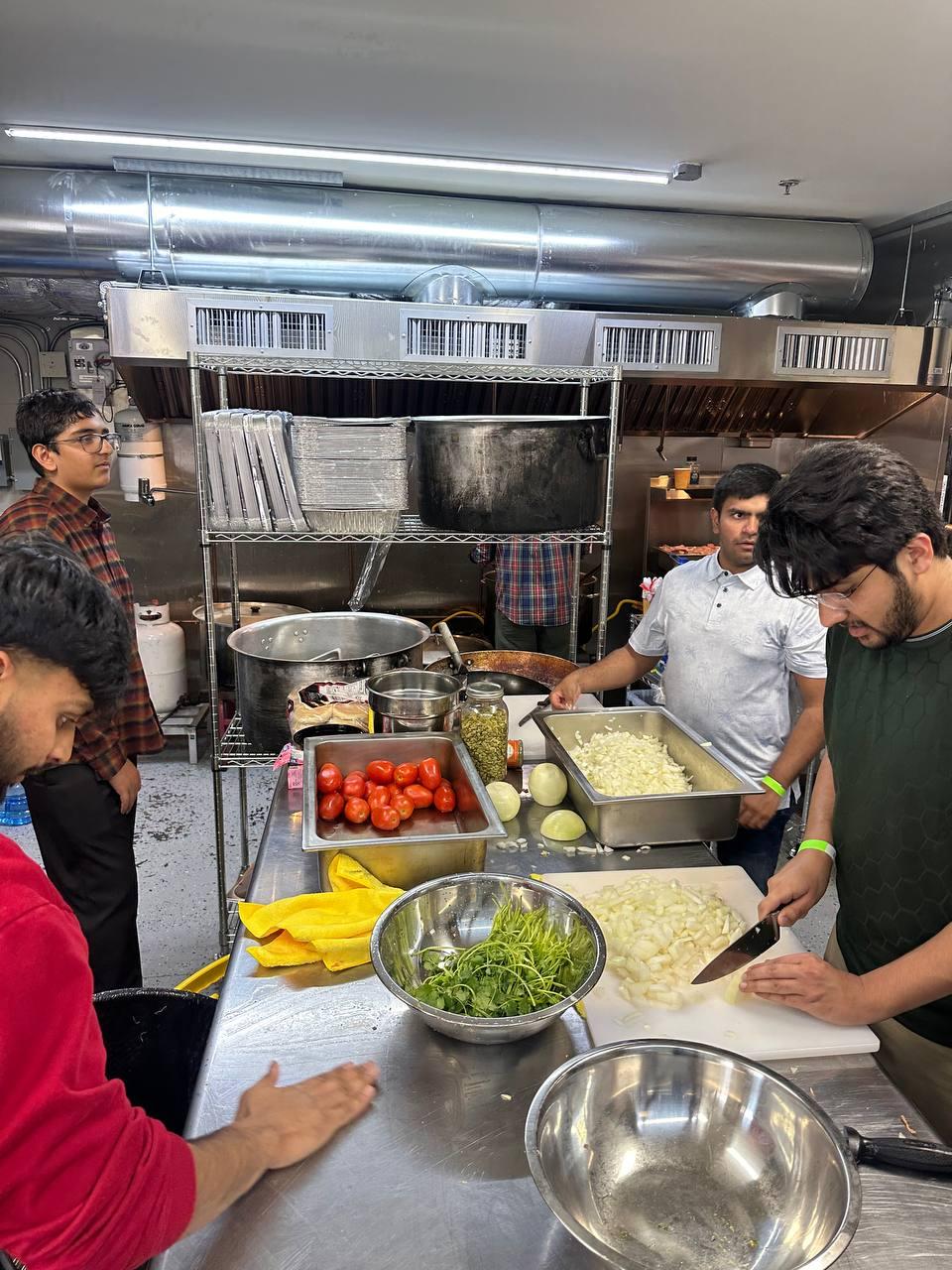 Khuddam preparing meals together at Bait-ul-Ehsan